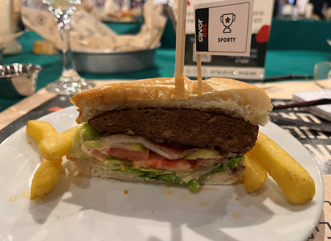 A plant-based hamburger, cooked by a robot developed by Israeli food-tech company SavorEat is served at a restaurant in Herzliya, Israel December 28, 2021. REUTERS/Steven Scheer