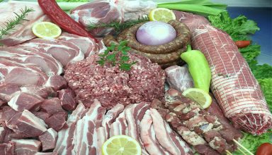 raw pork chops and spices on wooden table