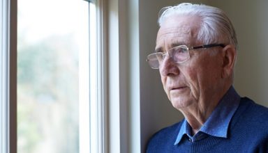 senior-msenior-woman-suffering-from-depression-looking-out-of-from-picture-id647653954