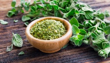 fresh-and-dried-oregano-herb-on-wooden-background-picture-id653084104