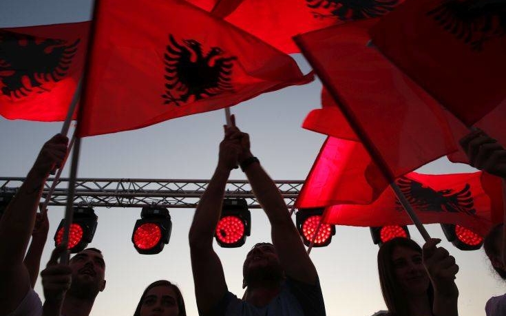 Supporters of prime minister Edi Rama wave Albanian flags during the last election rally in Vlora, southern Albania, Friday, June 28, 2019. Albania's municipal elections don't normally provoke much interest beyond the country's border, but the holding of this weekend's vote — or failure to do so — appears decisive for the tiny Western Balkan country in its bid to start full membership negotiations with the European Union. (AP Photo/Visar Kryeziu)