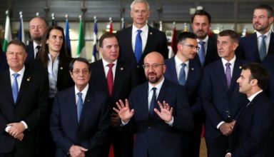 European Council President Charles Michel gestures next to French President Emmanuel Macron, Cypriot President Nicos Anastasiades, Romanian President Klaus Iohannis, Belgium's Prime Minister Sophie Wilmes, Sweden's Prime Minister Stefan Lofven, Slovenia's Prime Minister Marjan Sarec, Czech Republic's Prime Minister Andrej Babis, Latvia's Prime Minister Krisjanis Karins, Luxembourg's Prime Minister Xavier Bettel, Slovak Prime Minister Peter Pellegrini during a family photo opportunity at the European Union leaders summit in Brussels, Belgium December 12, 2019. REUTERS/Yves Herman