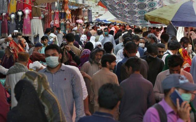 People shop at a busy market after the government relaxed the weeks-long lockdown that was enforced to help curb the spread of the coronavirus, in Rawalpindi, Pakistan, Wednesday, May 13, 2020. (AP Photo/Anjum Naveed)