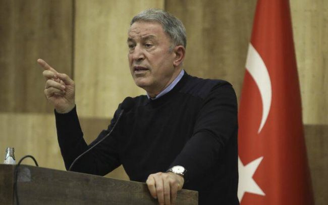 In this late Saturday, Dec, 26, 2020 photo, Turkey's Defense Minister Hulusi Akar addresses Turkish troops based in Libya, in Tripoli, Libya. Akar arrived in Tripoli on Saturday and met with the country's allies in the UN-supported government of Libya. (Turkish Defense Ministry via AP, Pool)