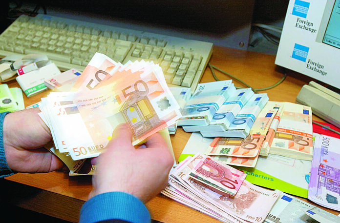 Some of the first euro notes to arrive in Britain being counted at the American Express Foreign Exchange situated on London's Haymarket, Wednesday Dec. 12, 2001. The euro notes which are common to all twelve Euro-land countries, will be available in 500, 200, 100, 50, 20, 10 and 5 denominations and become legal tender in 20 days time , replacing twelve similiar currencies including the French franc, German mark, and Spanish peseta. (AP Photo/Richard Lewis)