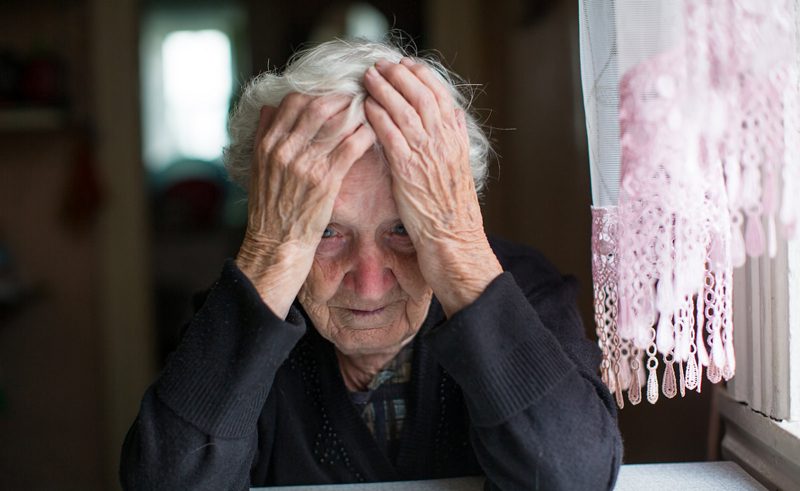 An elderly woman in a state of depression.