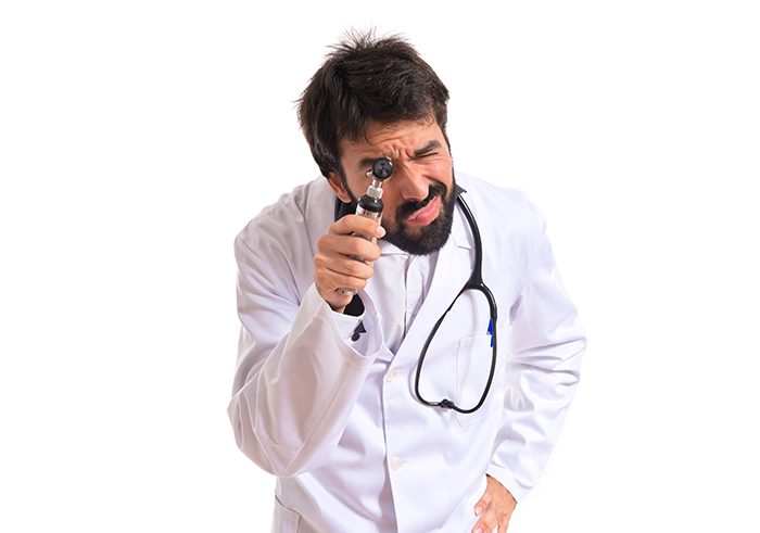 Otorhinolaryngologist with his otoscope over white background