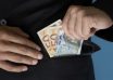 Businessman putting money in pocket