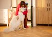 Dog,Meets,Its,Owner,At,The,Doorway,Of,Living,Room