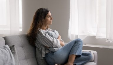 Serious,Pensive,Young,Woman,Thinking,On,Problem,,Hugs,Cushion,Seated