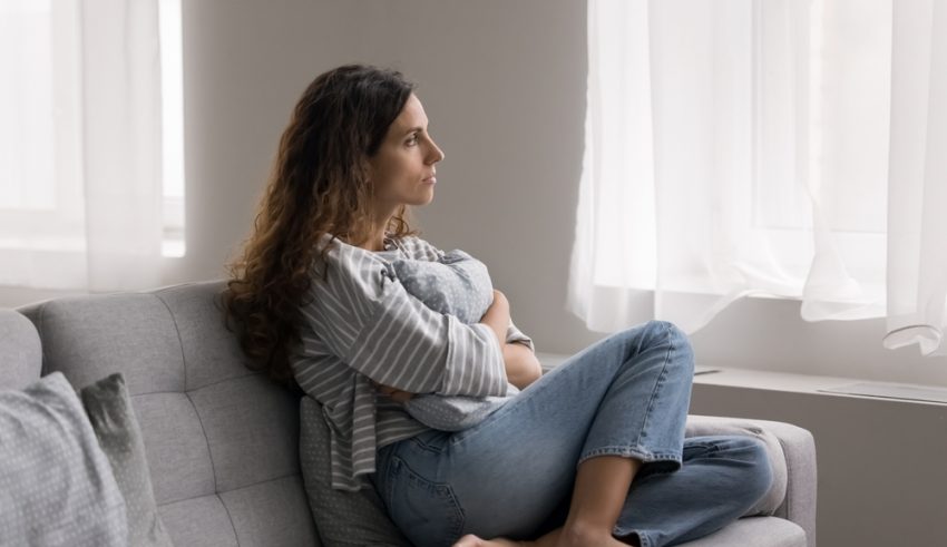 Serious,Pensive,Young,Woman,Thinking,On,Problem,,Hugs,Cushion,Seated