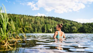 Swimming,In,Lake,In,Finland.,Woman,In,Summer,At,Beach.