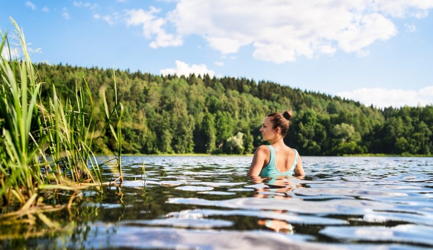 Swimming,In,Lake,In,Finland.,Woman,In,Summer,At,Beach.